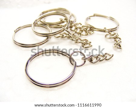 Metal ring and chain for key and trinket on white background.