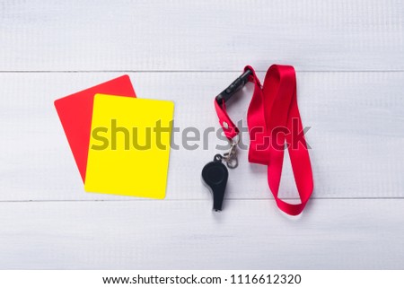 two penalty cards and a whistle for the judge, on a gray background