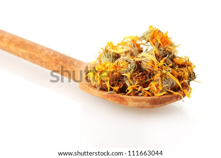 dried calendula flowers in wooden spoon, isolated on white