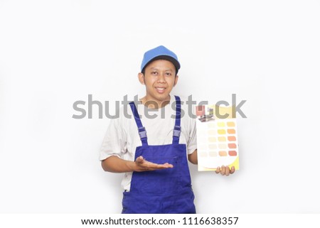 asian painter man with color swatches in your hand. rear view of painter man looking a color palette isolated.