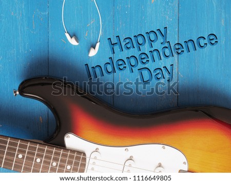 Old vintage guitar on blue wood, Happy independence Day