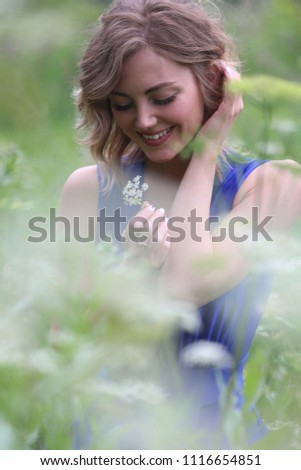 girl in a blue dress in a field