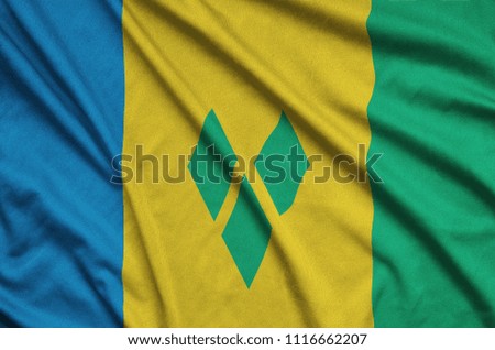 Saint Vincent and the Grenadines flag  is depicted on a sports cloth fabric with many folds. Sport team banner