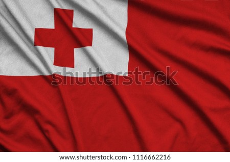 Tonga flag  is depicted on a sports cloth fabric with many folds. Sport team banner