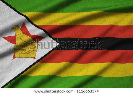 Zimbabwe flag  is depicted on a sports cloth fabric with many folds. Sport team banner