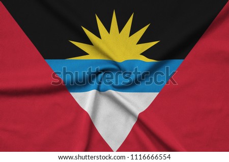 Antigua and Barbuda flag  is depicted on a sports cloth fabric with many folds. Sport team banner