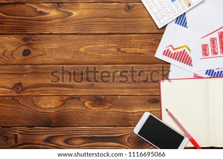 Top view of business paper chart or graph on wooden table