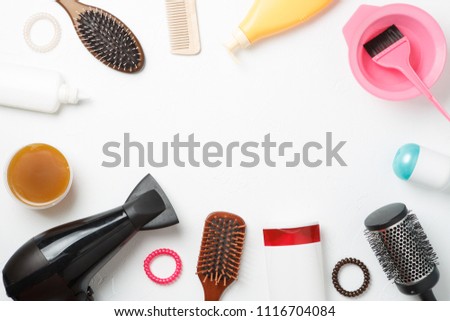 Photo accessories of hairdresser, hair dryer, combs located in circle on clean white background. Empty space for text