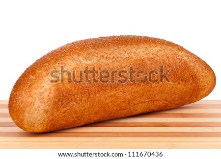 Fresh bread with bran on a cutting board on white background