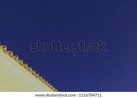 Clear sky photo with stars with building in foreground