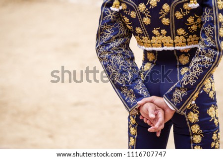 Bullfighter's dress and hands Royalty-Free Stock Photo #1116707747