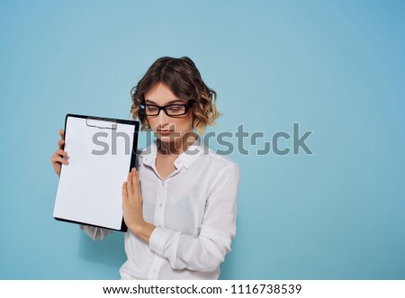Business woman with glasses holds a folder for documents in hands                            