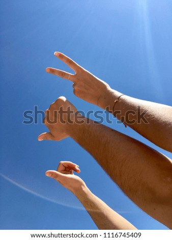 Summer hands gesture at blue sky