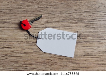Silver key for door with blank tag on for use in naming or editing