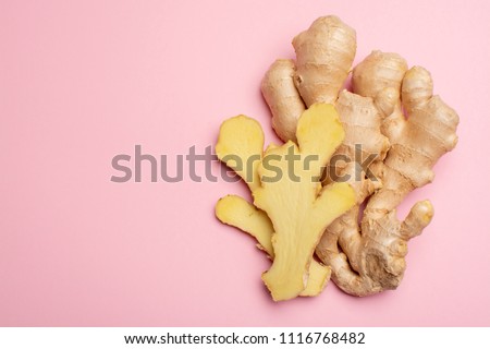 Trendy food flat lay concept on light pink background with fresh big ginger root close up copy space isolated Royalty-Free Stock Photo #1116768482