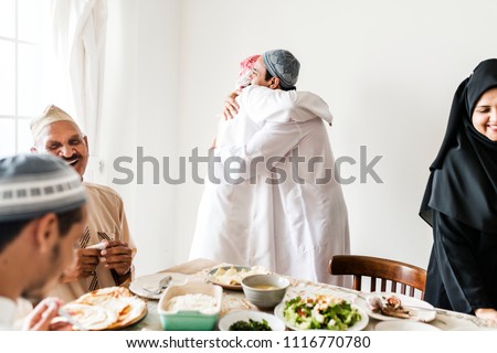 Muslim men hugging at lunchtime Royalty-Free Stock Photo #1116770780