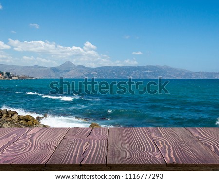 Wood table outside with seaview in beautiful summer day. Rustic wooden desk outdoor on sea view background. Template mock up with countertop for product advertising