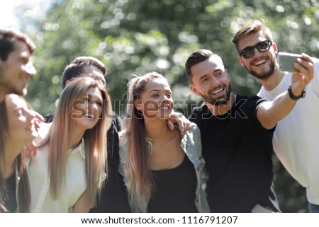 group of friends taking selfies in the Park