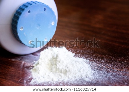 Baby talcum powder container on wooden background Royalty-Free Stock Photo #1116825914
