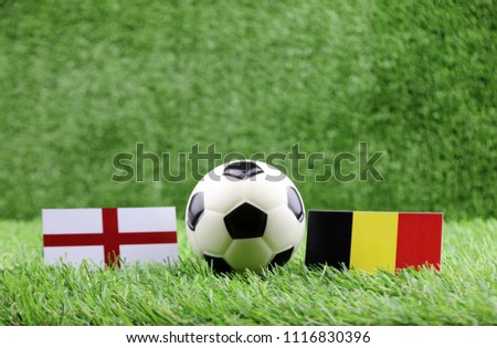 ball with England VS Belgium flag match on Green grass football 2018 Royalty-Free Stock Photo #1116830396