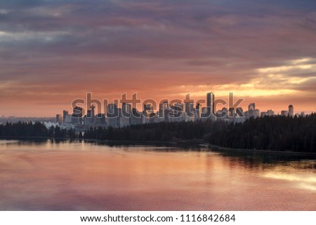 Colorful dramatic sunset color sky over Stanley Park and downtown city Vancouver BC British Columbia Canada