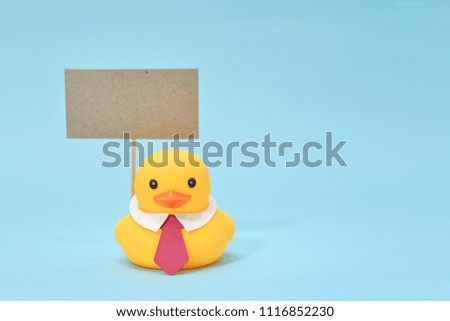 Feedback concept, rubber duck is holding blank signboard.