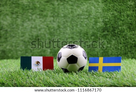 ball with Mexico VS Sweden flag match on Green grass football 2018 Royalty-Free Stock Photo #1116867170