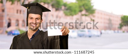 Graduate Man Holding Placard, Outdoor