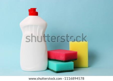 means for washing dishes and sponges on a colored background. household chores, washing dishes
