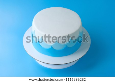 Сake for the child's birthday, decorated with sea waves on a blue background. Picture for a menu or a confectionery catalog.