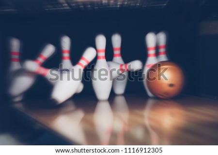 motion blur of bowling ball and skittles on the playing field