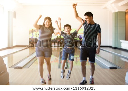 Family having fun at bowling club after skittles bowling ball ,blurry and soft focus