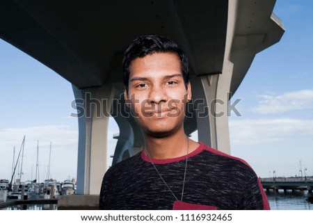 Hispanic model looking straight forward. Photo taken under Clearwater Memorial  Causeway Bridge, Fl, USA. 