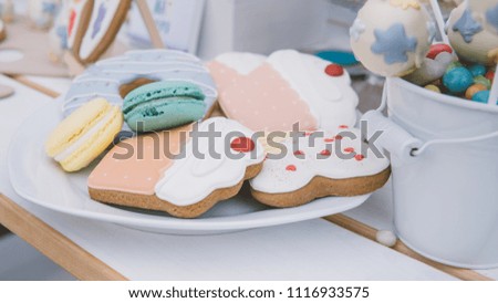 cooking at a children's party, cooking at a children's party. Macaroons, glazed gingerbread, colored cakes, muffins with pills