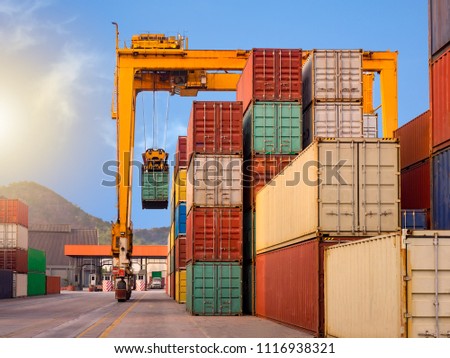 The RTG(Rubber Tried Gantry Cranes) is moving full loaded containers at industrial port and container yard   for prepare delivery to customers Royalty-Free Stock Photo #1116938321