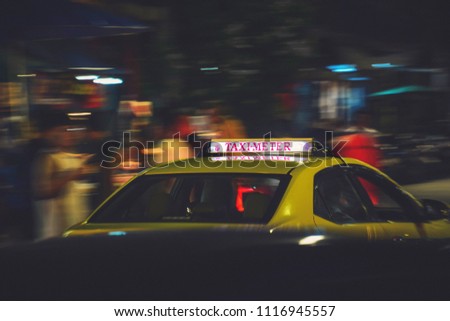 Taxi car on the street at night
