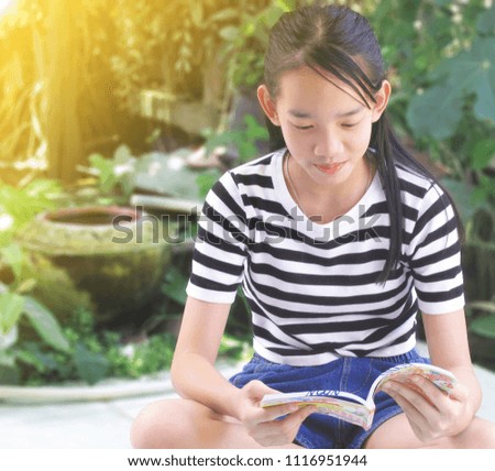 Girl reading cartoon book
