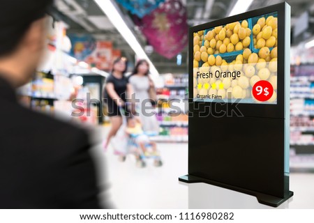 Intelligent Digital Signage , Augmented reality marketing and face recognition concept. Interactive artificial intelligence digital advertisement fresh orange organic farm in retail shopping Mall.