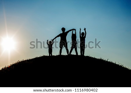 Backlight portrait of happy family playing on a summer day outdoors at sunset in the sun.        