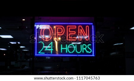 Open 24 hours sign at night