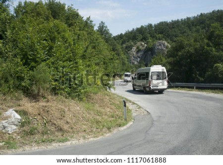 two mini buses driving up the hill Royalty-Free Stock Photo #1117061888