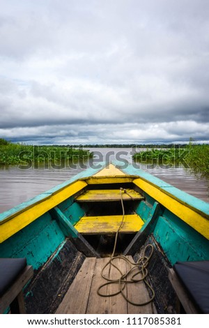 Sailing in the Amazon river in a boat in a cloudy day.