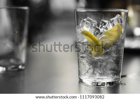 empty glass of ice and a slice of lemon blurred background