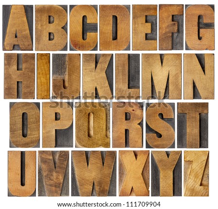 complete English alphabet - collage of 26 isolated vintage wood letterpress printing blocks, scratched and stained by ink patina, gothic bold extended font Royalty-Free Stock Photo #111709904