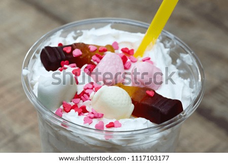 Decoration of a milkshake with confectionery. Cold sweet dessert.