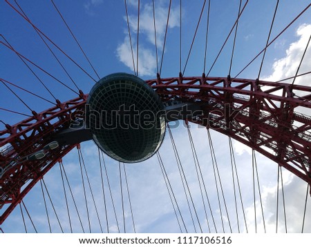 Observation cabin / capsule / gondola on top of cable-stayed metal bridge against blue sky. Close-up photo of modern architecture. Urban cityscape fragment.