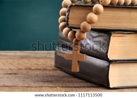 The wooden cross hang on stack  book