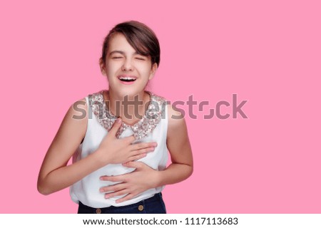 Portrait against pink background of a laughing girl