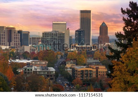 Portland Oregon downtown cityscape with Mount Hood during colorful sunrise in Fall season