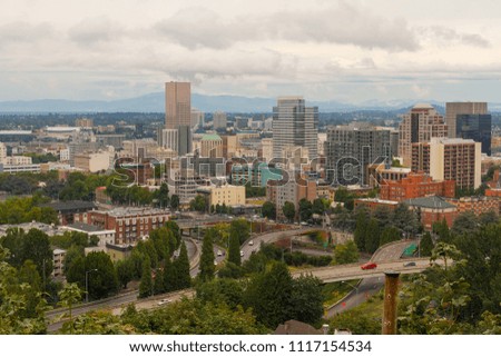 Portland Oregon downtown cityscape scenic view by freeway nestled among trees
